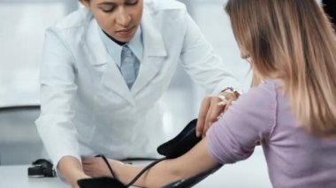 sphygmomanometer ile hasta kan basıncını ölçen afro-amerikan doktor