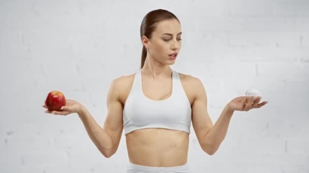 Hesitated Woman Holding Red Apple Marshmallow Choosing Apple Smile — Stock Video