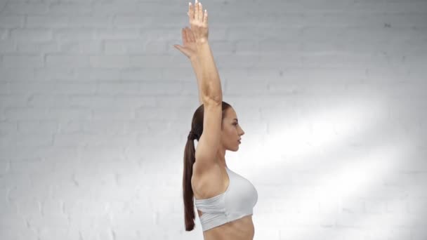 Woman Ponytail Raising Hands Practicing Warrior Pose — Stock Video