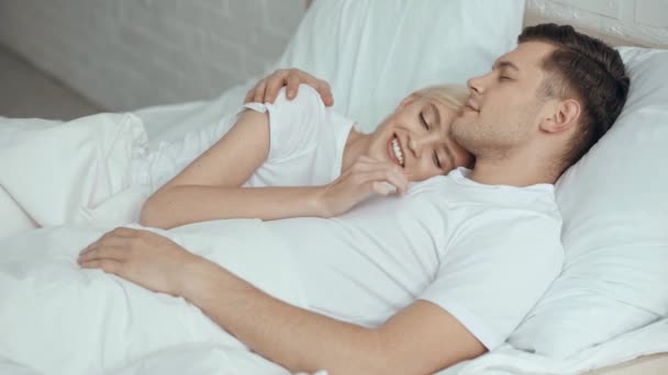 Beautiful Woman Stroking Embracing Smiling Sleeping Man Bed — Stock Video