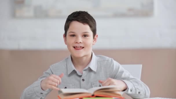 Vooraanzicht Van Glimlachende Preteen Jongen Zittend Bureau Tonen Thumbs Rock — Stockvideo