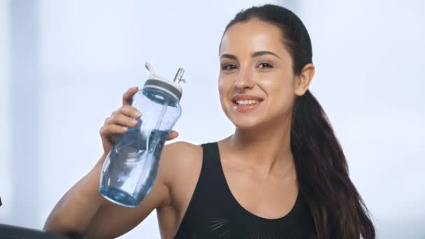 Όμορφη Χαμογελαστή Αθλητική Γυναίκα Κοιτάζοντας Την Κάμερα Και Πόσιμο Νερό — Αρχείο Βίντεο