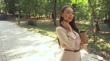 kahve ile genç kadın parkta yürümeye gitmek