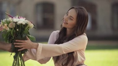 genç kadın çim en oturmuş ve çiçek almak