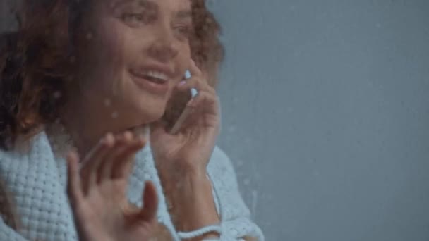 Cheerful Woman Talking Smartphone Glass Window Raindrops — Stock Video