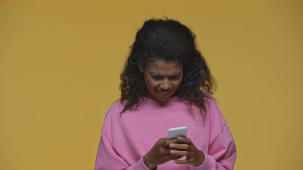 Happy African American Girl Using Smartphone Showing Yeah Gesture Isolated — Stock Video