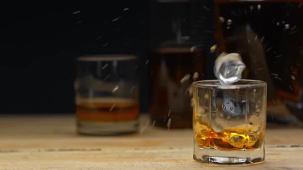 Slow Motion Ice Cube Falling Glass Whiskey Isolated Black — Stock Video