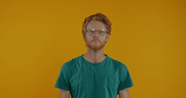 Irritated Redhead Man Covering Ears Showing Fists Isolated Yellow — Stock Video