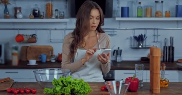 Woman Apron Checking Ingredients While Holding Smartphone — Stock Video