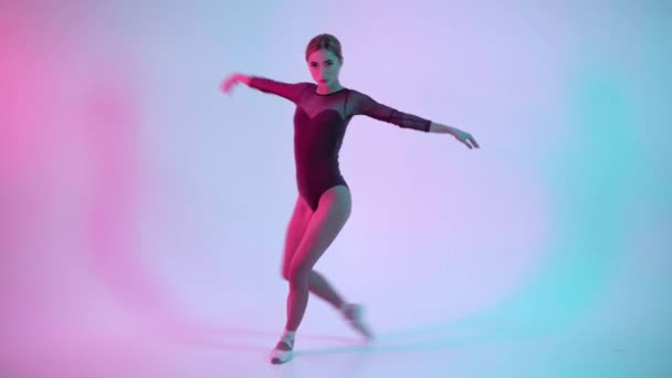 年轻的芭蕾舞演员在蓝色和粉色的背景下表演舞蹈 — 图库视频影像