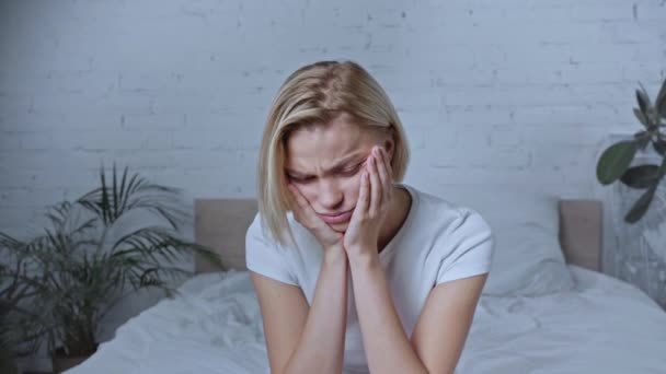 Frustrasi Wanita Pirang Duduk Tempat Tidur Dan Menyentuh Wajah — Stok Video