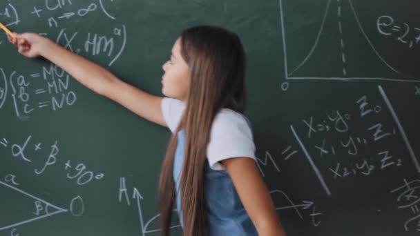 Child Holding Pen While Showing Math Formulas Chalkboard — Stock Video