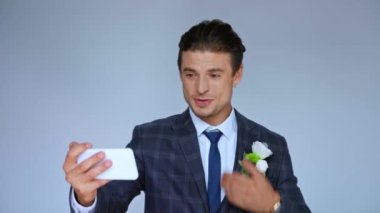 Mutlu damat el sallarken görüntülü arama gri üzerine izole edildi.