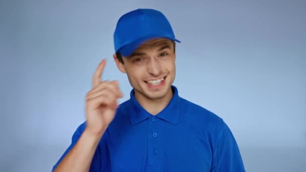 Cheerful Delivery Man Blue Cap Gesturing Grey — Stock Video