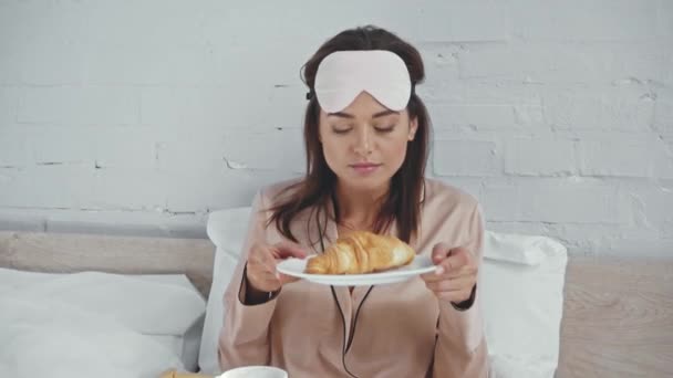 Pleased Woman Smelling Delicious Croissant Closed Eyes — Stock Video