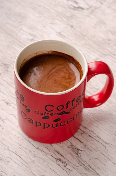 Red Coffee mug on wooden background. Americano