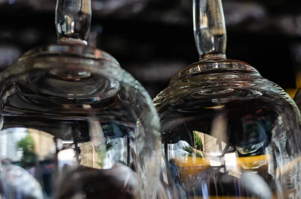 Close-up of two clean empty glasses above the bar counter. Interior of pub, bar or restaurant