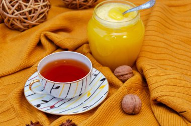 Merhaba Sonbahar arka plan. Parlak sarı yün kazak, çay fincan, bal, doğal dekoratif asma topları, anason yıldız ve ceviz. Sonbahar coziness kavramı