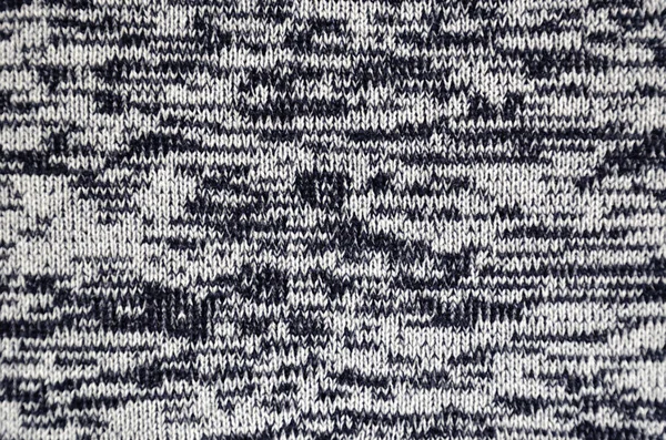 Melange gebreide stof gemaakt van gemengd garen. Abstracte blauwe en witte getextureerde achtergrond. Bovenaanzicht. Close-up — Stockfoto