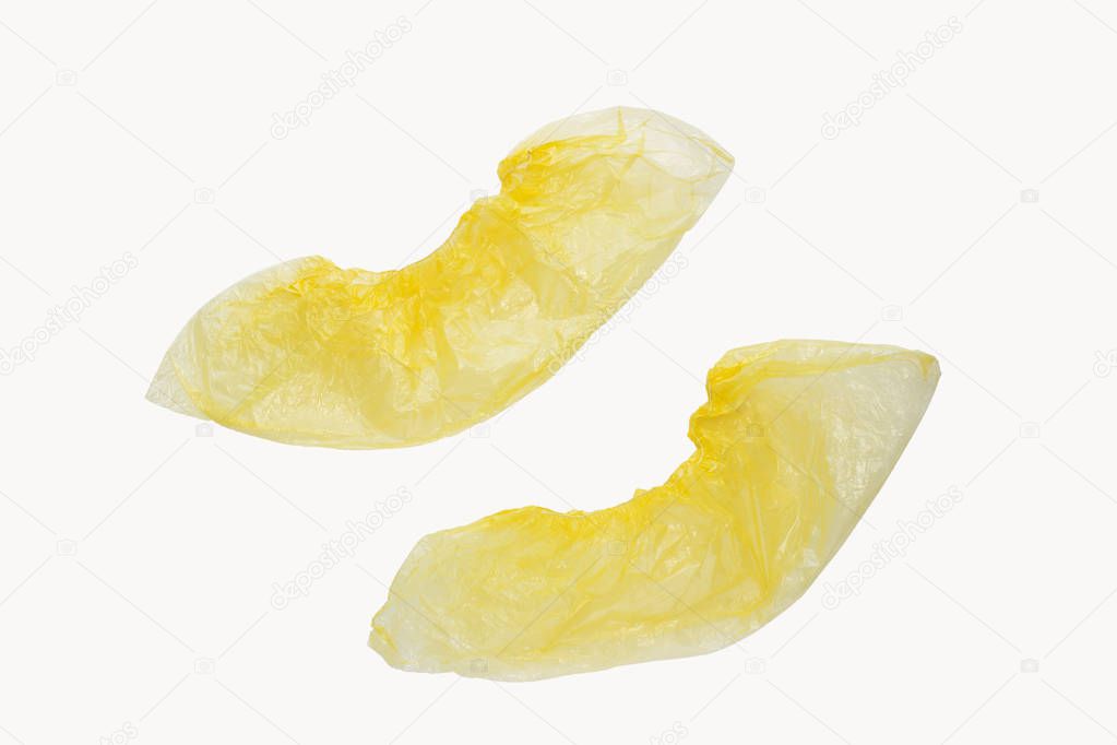 Two medical yellow shoe covers overshoes isolated on white background. Catalog top view