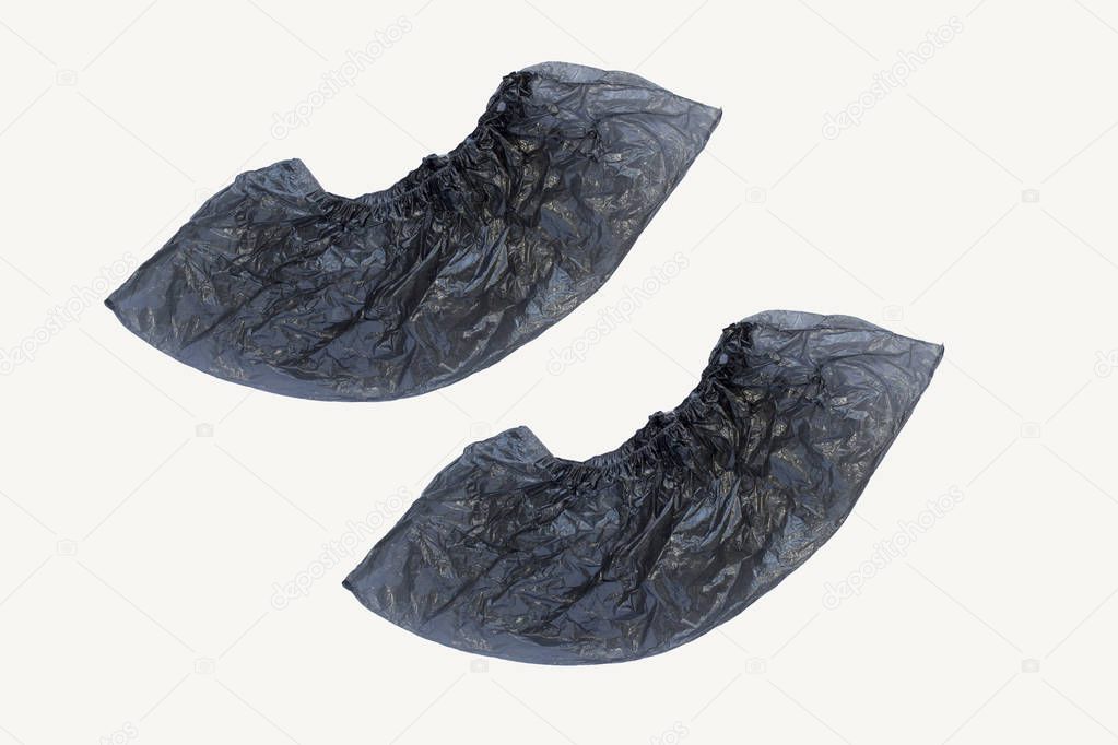 Two medical black shoe covers overshoes isolated on white background. Catalog top view