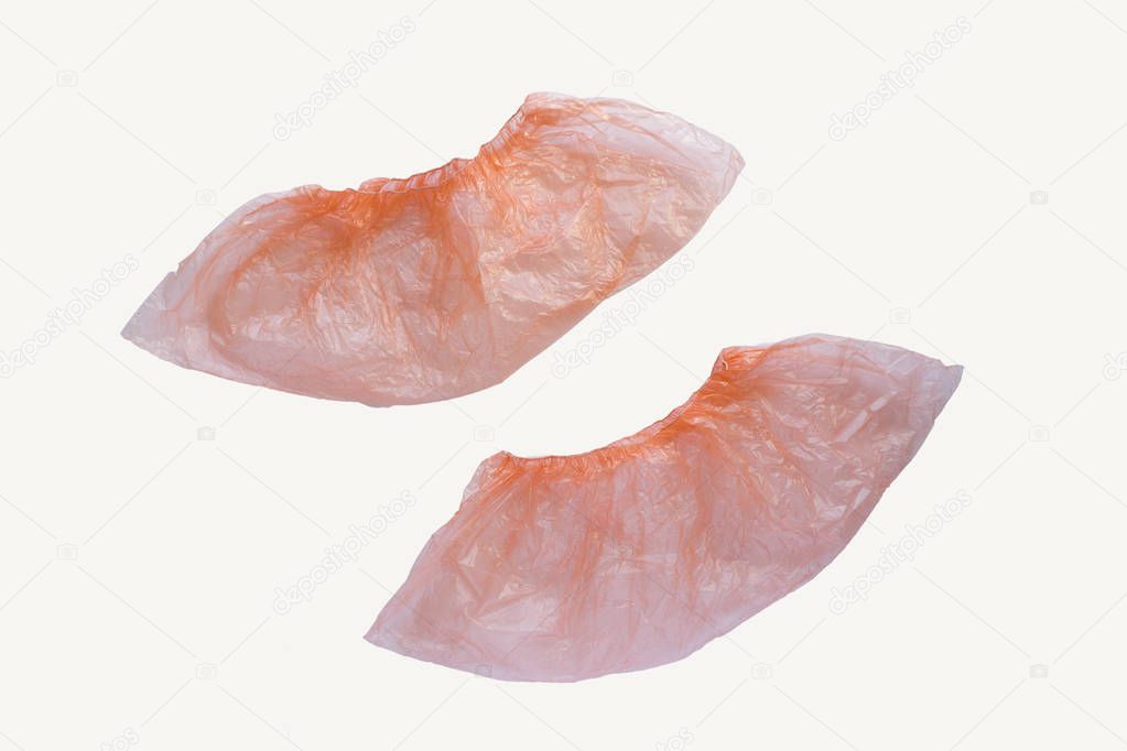 Two medical orange shoe covers overshoes isolated on white background. Catalog top view