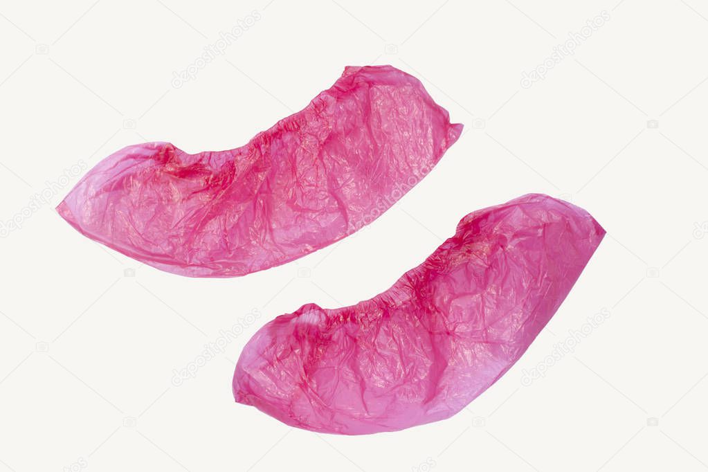 Two medical pink shoe covers overshoes isolated on white background. Catalog top view