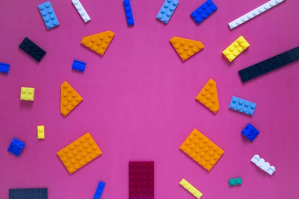 Background for children's site, for the menu. Children's constructors on pink. Multi-colored cubes. Games for motor developing memory and mind.