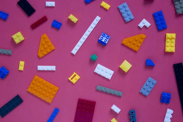 Background for children's site, for the menu. Children's constructors on pink. Multi-colored cubes. Games for motor developing memory and mind.