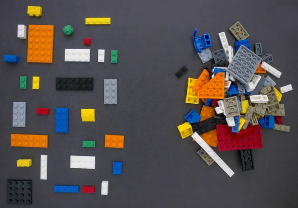 Children's constructors on black. Multi-colored cubes. Games for motor developing memory and mind. The concept of chaos and order. — Stock Image Children Constructors Black Multi Colored Cubes Games Motor Developing Memory Stock Picture