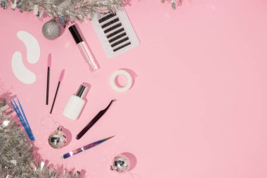 New year's flatley. Tools for eyelash extension on a pink background, top view. Patches, artificial eyelashes, brushes, glue, microbrushes. Christmas. Background for the lashmaker. clipart