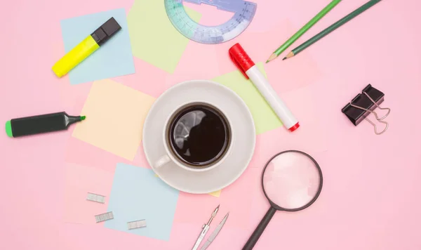 The concept of the office, a coffee break, a break from work. Office supplies in the form of a frame, a Cup of coffee, empty note papers. Topview, copyspace.