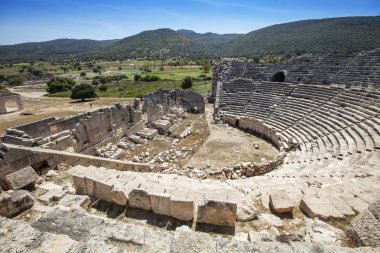 Patara (Pttra). Ruins of the ancient Lycian city Patara. Amphi-theatre and the assembly hall of Lycia public. Patara was at the Lycia (Lycian) League's capital. Aerial view shooting. Antalya, TURKEY clipart