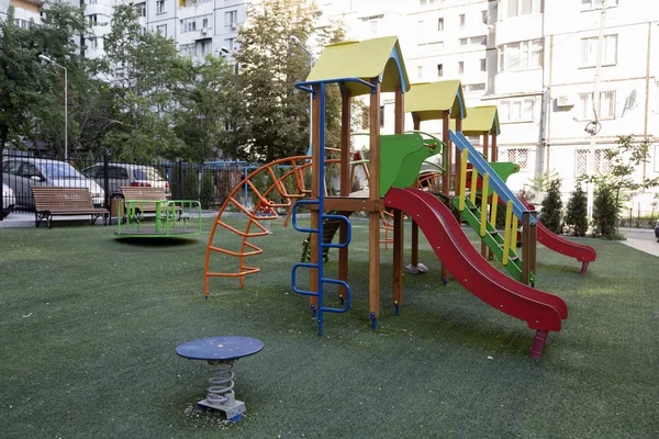 Modern courtyard in the new housing building. Colourful playground for children in public housing block.