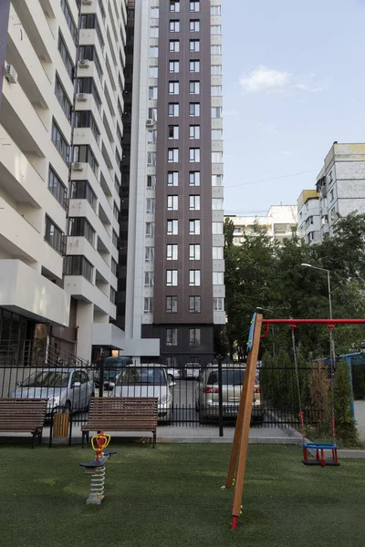 Modern courtyard in the new housing building. Colourful playground for children in public housing block.