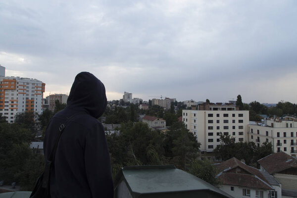 The man is looking on the city. Beautiful top view to the central district of Chisinau. In this image are the Colina Puskin district and the President Palace.