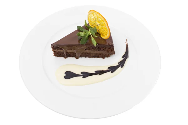 Chocolate cake with mint and slice of orange. — Stock Photo, Image