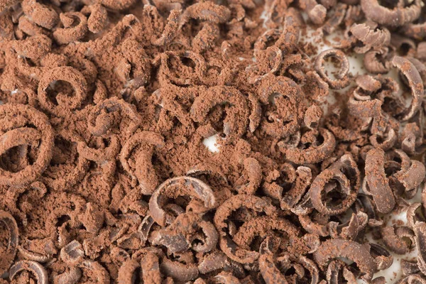 Dark grated chocolate covers the entire area. — Stock Photo, Image