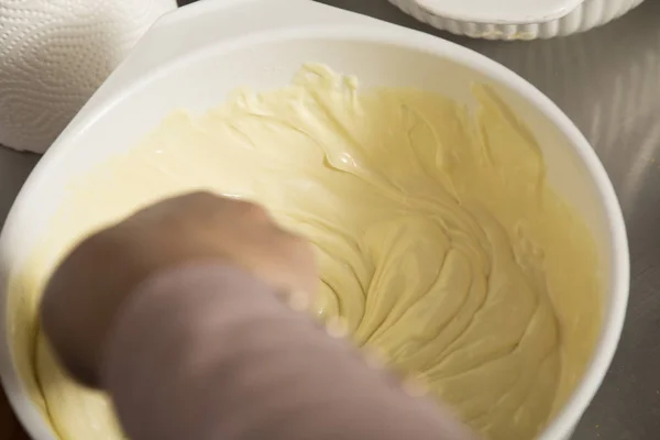 Размешивание расплавленного белого шоколада в миске . — стоковое фото