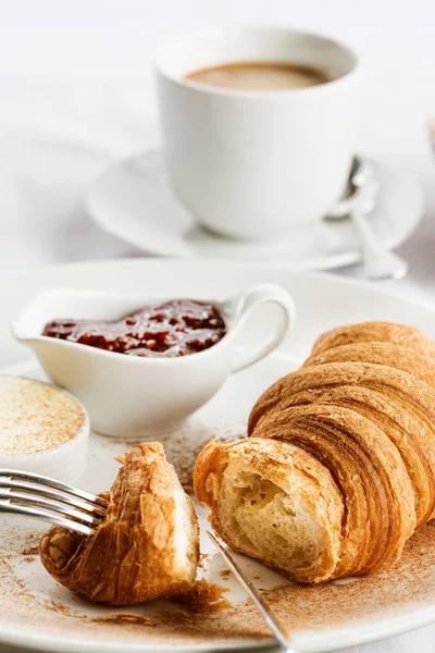 Croissant with strawberry jam and coffee in Paris