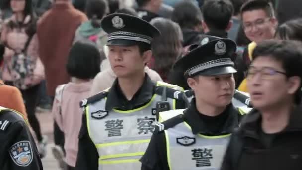 Shanghai Police Officers Slowly Patrolling Crowded Street — Stock Video