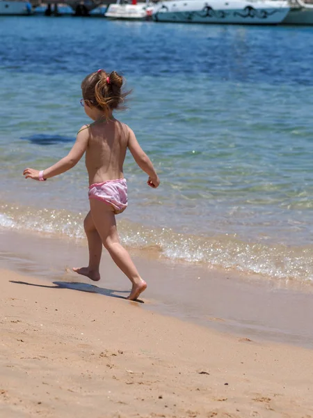 海の砂浜で遊ぶヨーロッパの外観の4歳の女の子の肖像画 — ストック写真