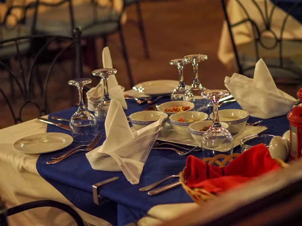 served tables at a restaurant with no people on the street preparing to receive visitors