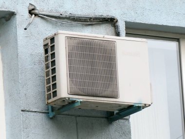 Evin ön cephesinde eski bir havalandırma ünitesi var.