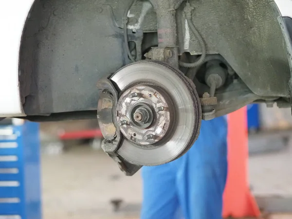 replacement of old brake pads in the front wheel of the car