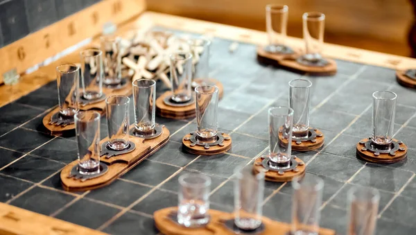 alcoholic board game sea battle with stacks of glass glasses
