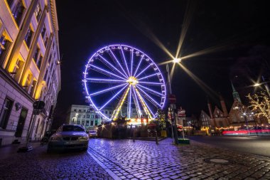 Lubeck, Germany - December 25, 2017: Lubeck Ferris Wheel. Long exposure shot. Christmas time.
