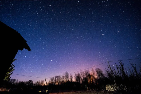 Starry sky over old buildings