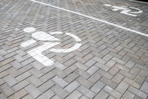 Road marking on asphalt. Painted signs on the roadway for drivers of various vehicles. Dotted line and arrows. Belarus