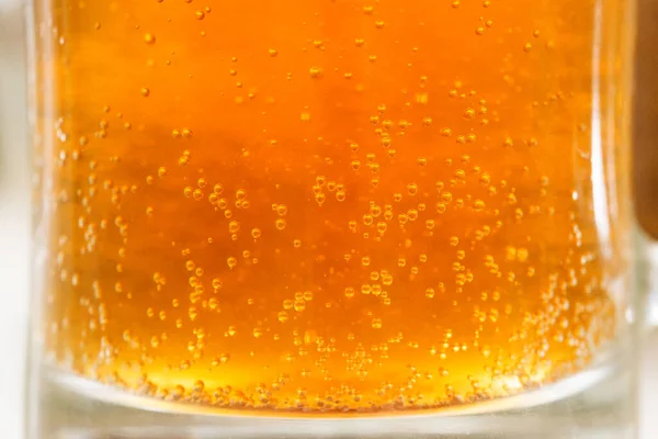 Bière avec dans fond de bulles de verre — Photo